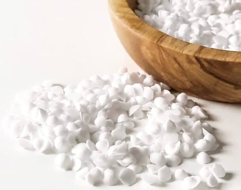 Cetyl Alcohol in wooden bowl on a white background