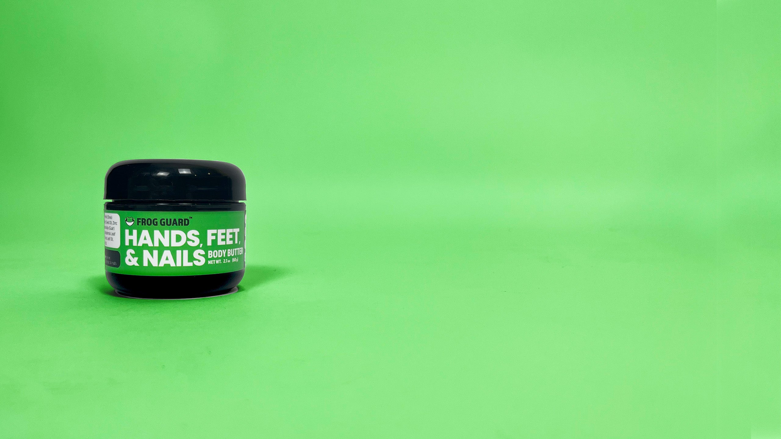 Jar of 'Hands Feet & Nails' cream on a green background