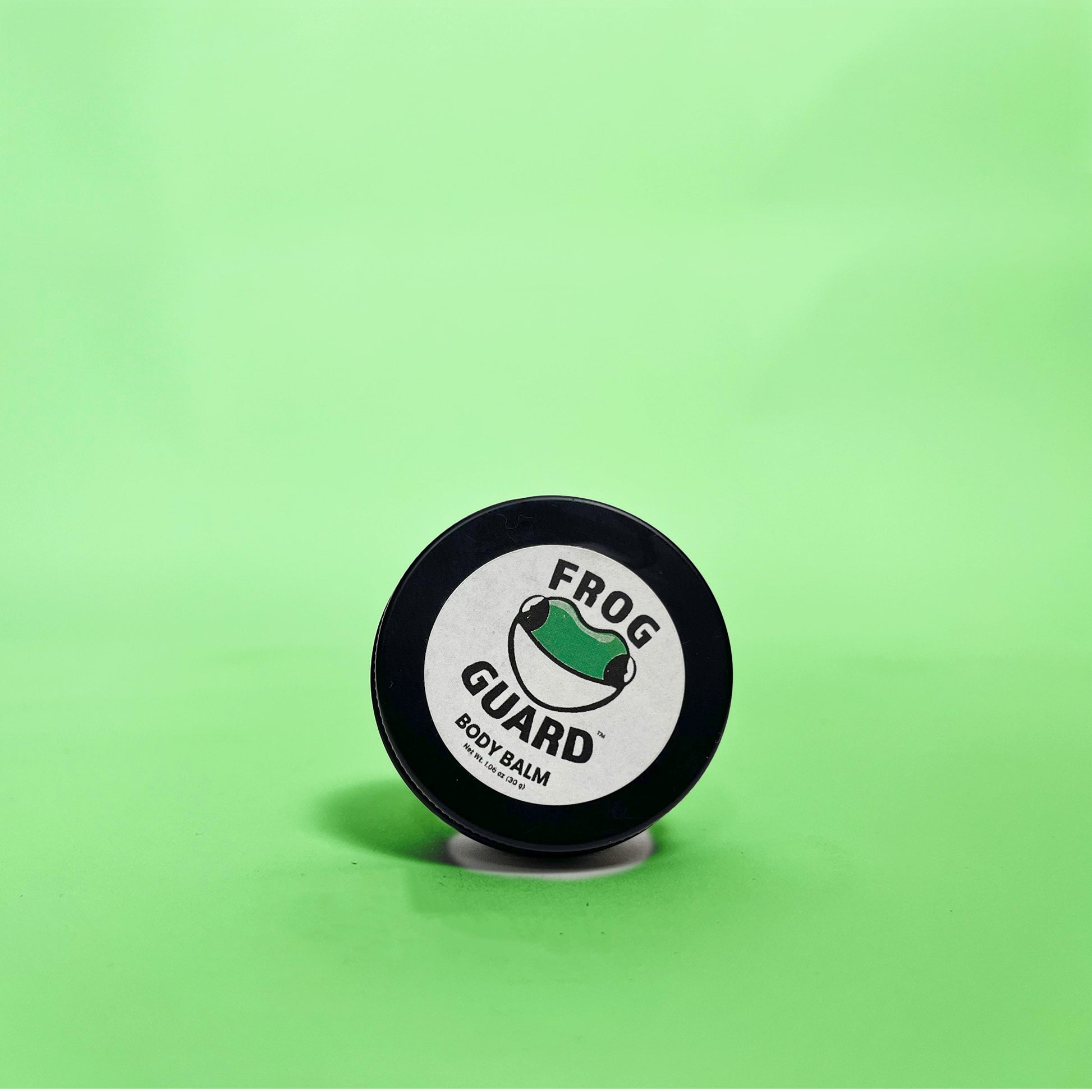 Frog Guard body balm container on a green background
