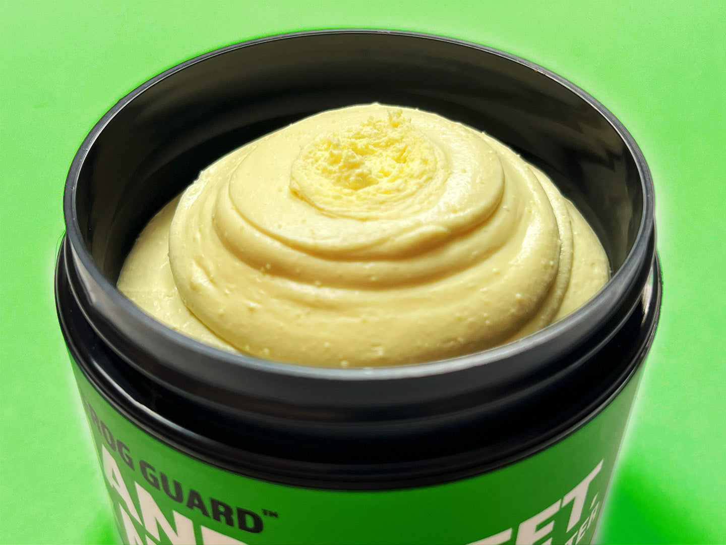Photo of Frog Guard 'Hands Feet & Nails' opened up, top-down perspective of creamy body butter texture.