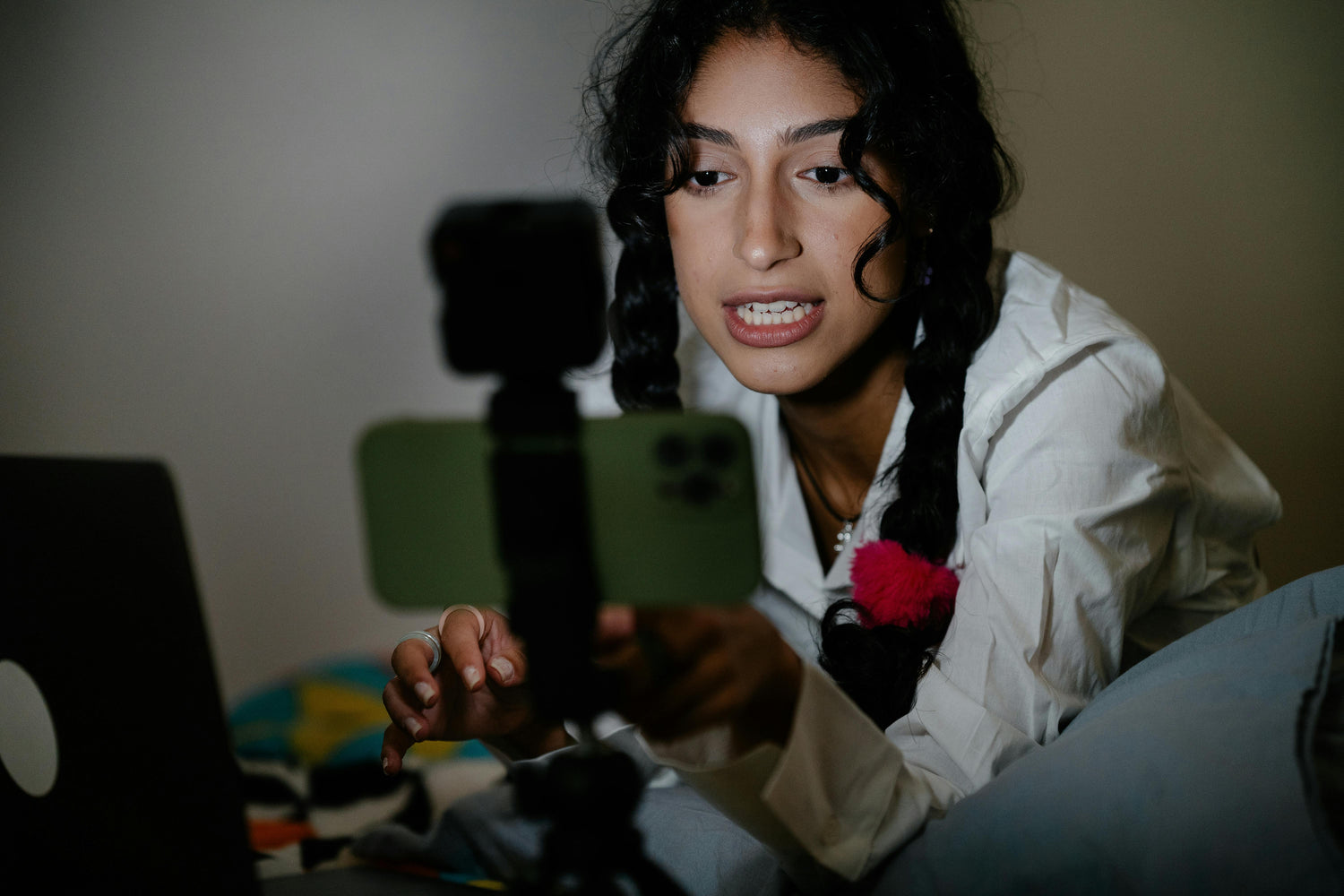 Person using a smartphone with a tripod on a blurred background